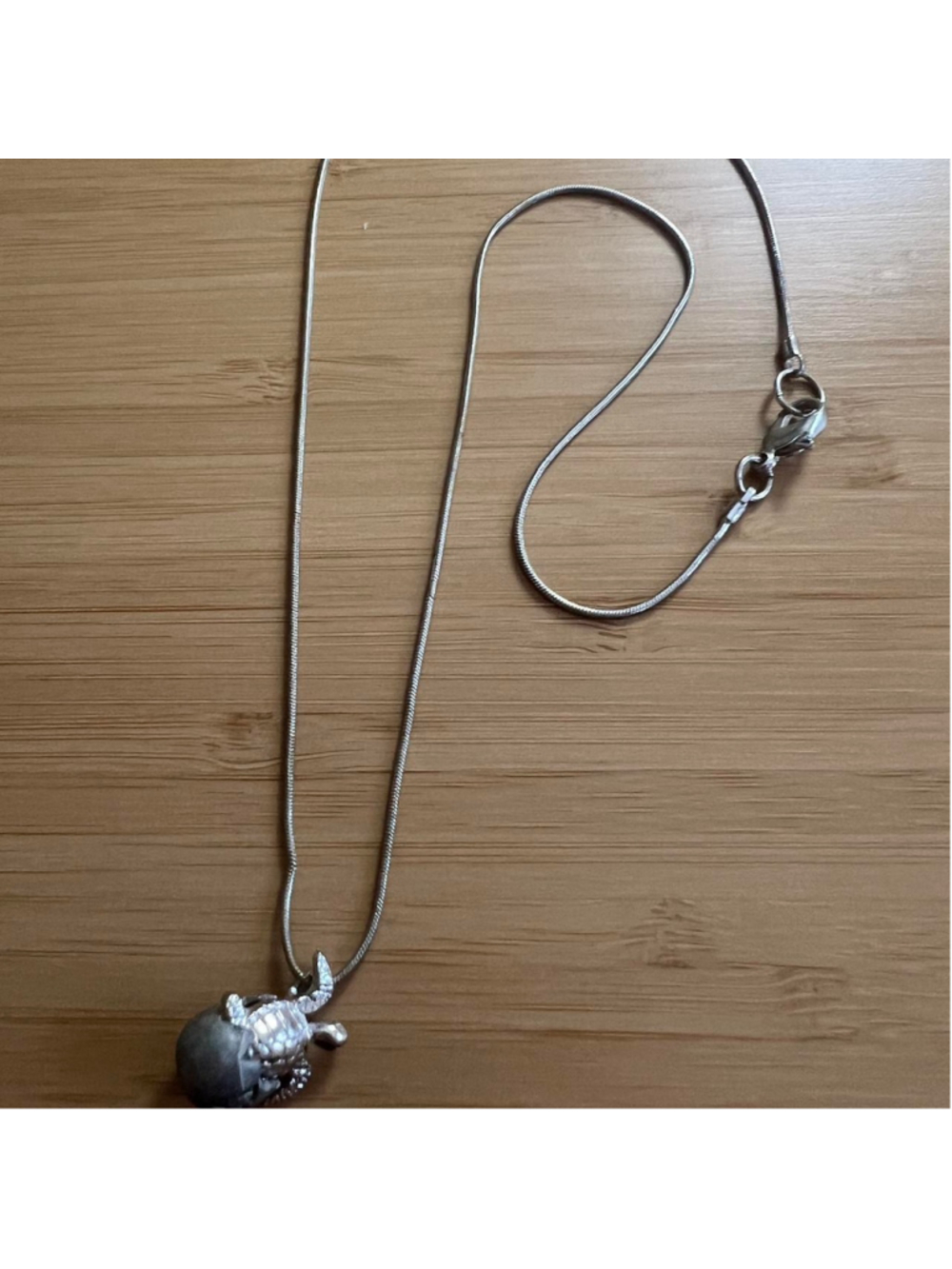 Silver hatching turtle necklace